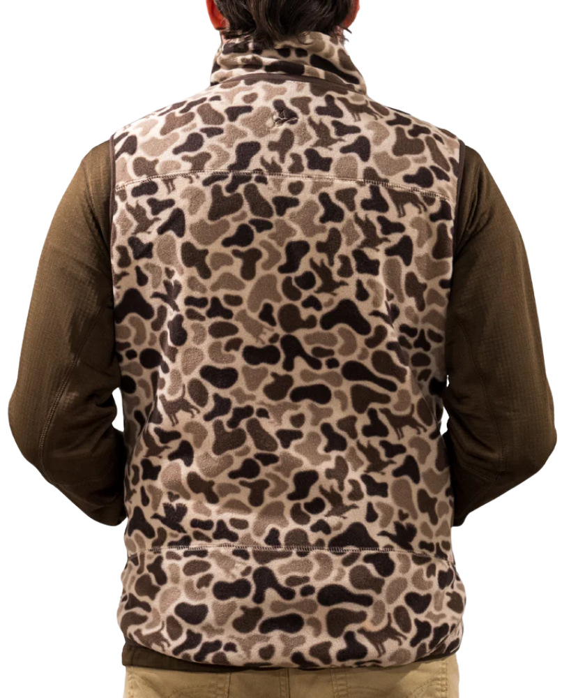Person wearing a camouflage vest over a brown shirt on a white background