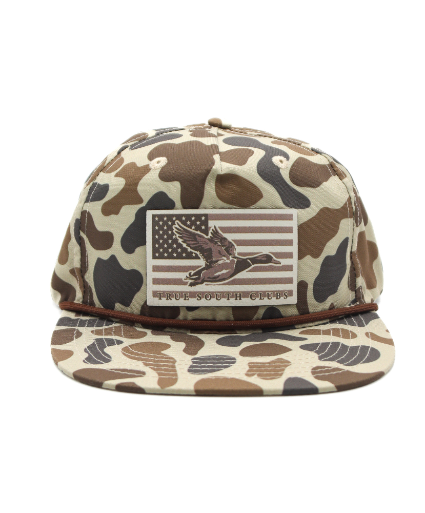Camouflage-patterned cap with an American flag and duck design on a white background