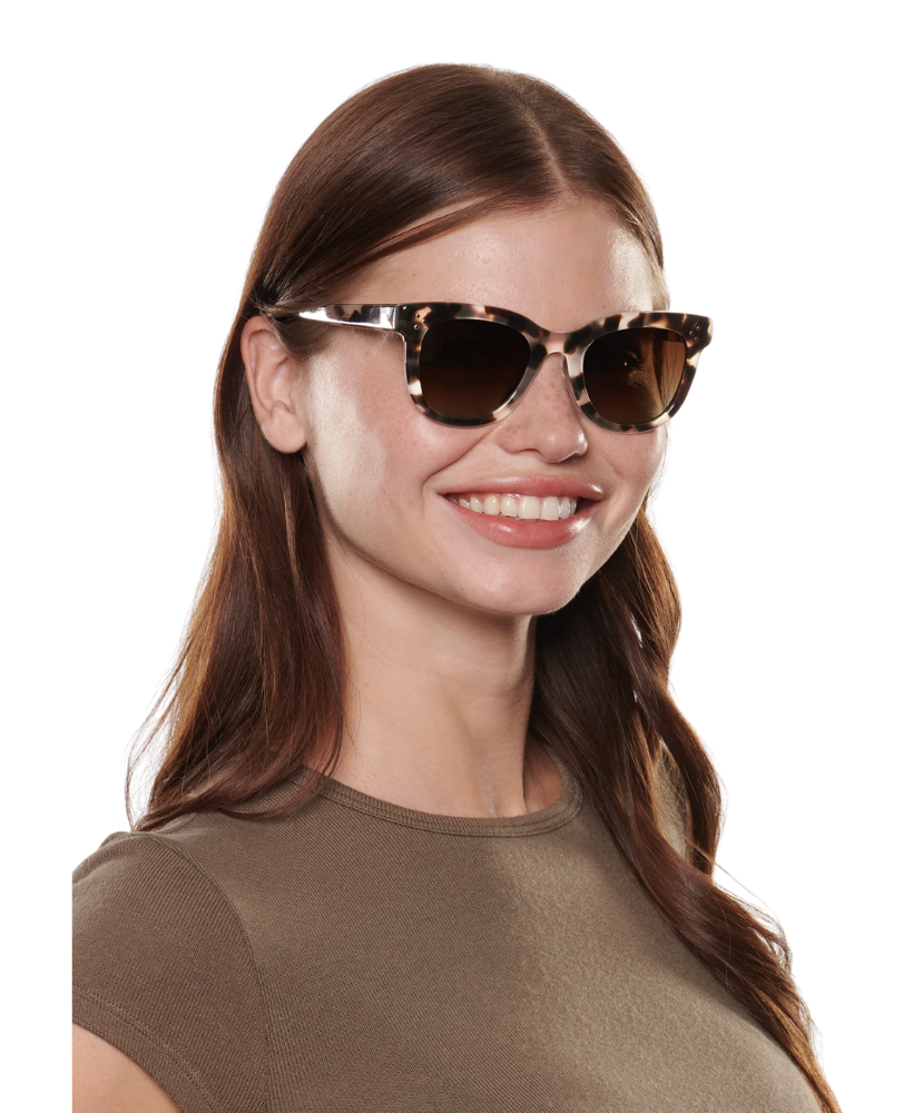 Woman wearing cat-eye sunglasses on a white background