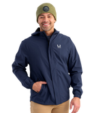 Man wearing a HUK navy jacket with a brand logo on a white background