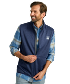 Man wearing a blue fleece vest over a plaid shirt on a white background HUK GEAR VEST