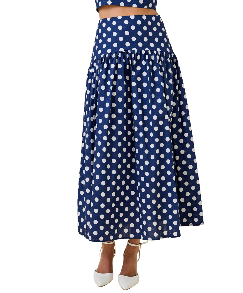 Navy blue skirt with white polka dots on a white background