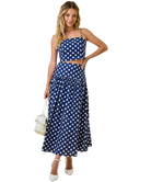 Woman wearing a blue polka dot dress on a white background