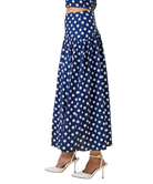 Navy blue skirt with white polka dots worn by a person on a white background