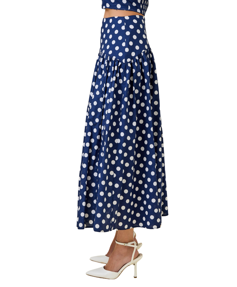 Navy blue skirt with white polka dots on a white background