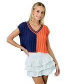 Woman wearing a two-tone top with blue and orange colors on a white background