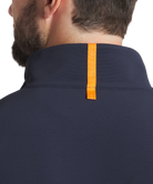 Man wearing a navy blue pullover with a white background