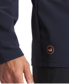 Navy blue jacket with a logo on the chest against a white background