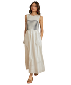 Woman wearing a sleeveless dress with a striped bodice and white skirt on a white background