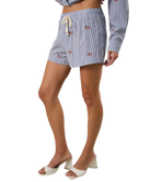 Person wearing blue STRIPED shorts with american flags on a white background