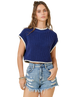 Woman wearing a blue knit top and denim shorts on a white background