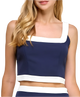 Navy and white sleeveless top worn by a model on a white background