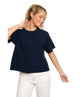 Woman wearing a navy blue shirt and white pants on a white background