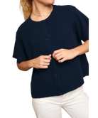 Navy blue cardigan worn by a person on a white background