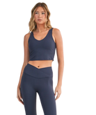 Woman wearing a navy blue athletic outfit on a white background