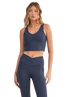 Woman wearing a navy blue athletic outfit on a white background