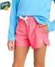 Person wearing pink shorts and a blue long-sleeve shirt with a 'Youth' logo.