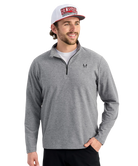 Man wearing a gray pullover with a HUK logo and a cap on a white background