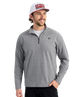Man wearing a gray pullover with a HUK logo and a cap on a white background