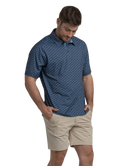 Man wearing a blue golf cart patterned polo shirt and beige shorts on a white background