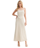 Woman wearing a beige slip dress on a white background