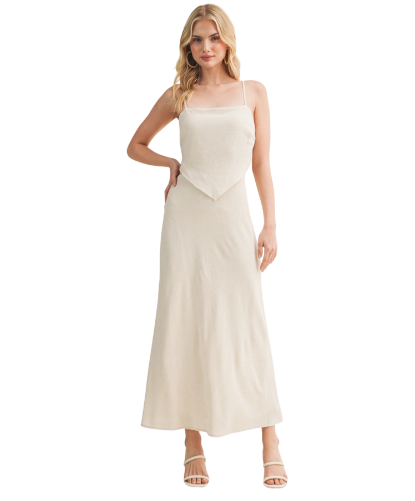 Woman wearing a beige slip dress on a white background