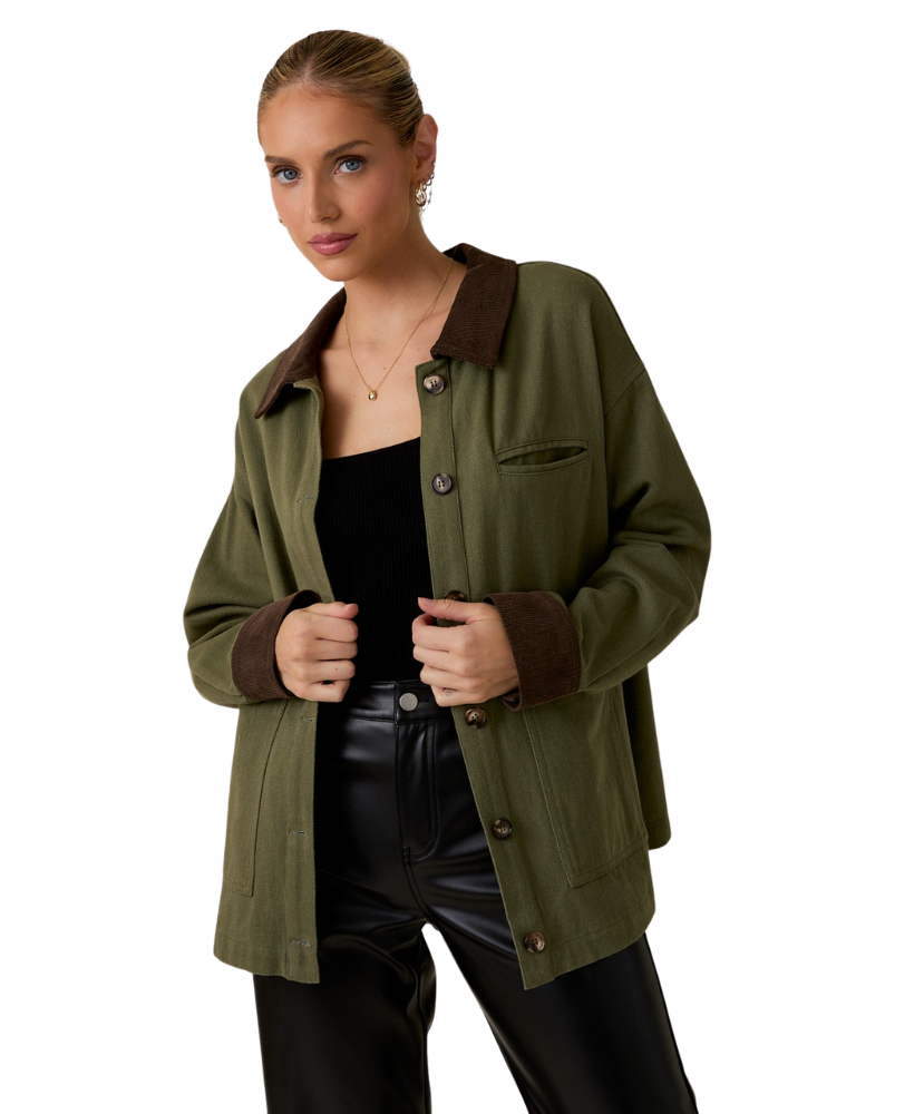 Woman wearing a green jacket with brown collar and cuffs on a white background