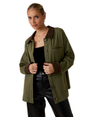 Woman wearing a green jacket with brown collar and cuffs on a white background