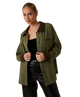 Woman wearing a green jacket with brown collar and cuffs on a white background