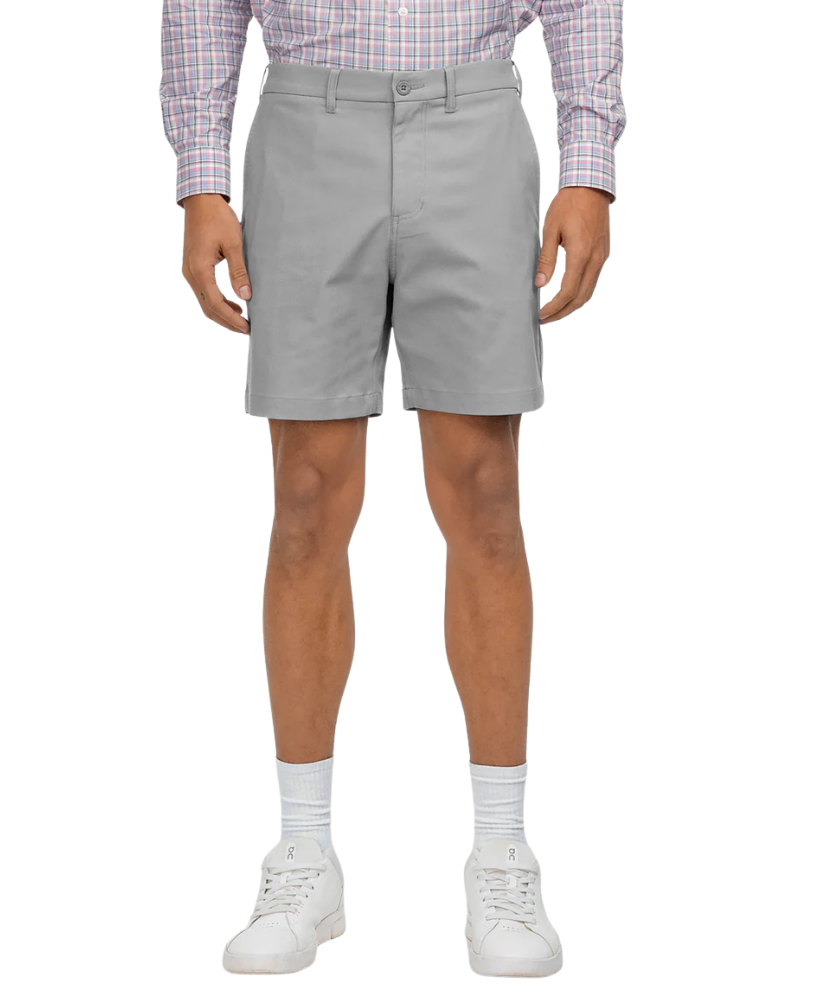 Person wearing light gray shorts on a white background