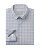Folded checkered shirt with brand label on a white background