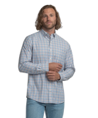Man wearing a blue checkered shirt on a white background