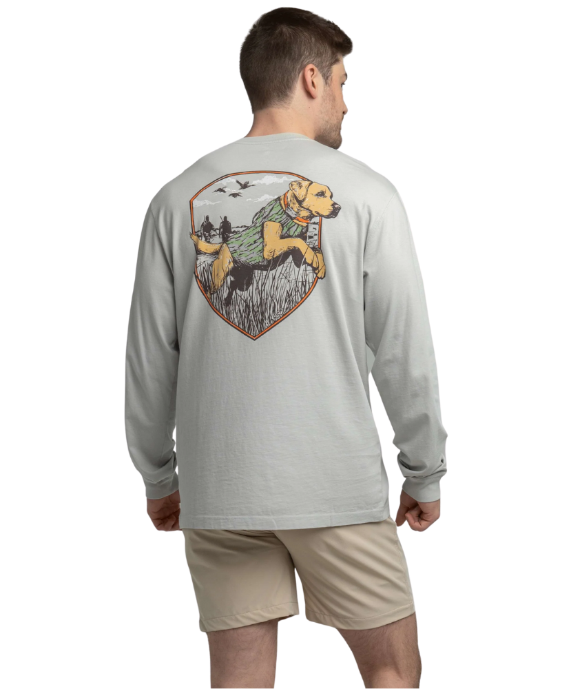 Man wearing a long-sleeve shirt with a graphic of a dog and nature on the back, on a white background.
