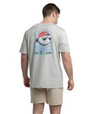 Man wearing a gray t-shirt with a graphic design on the back, standing against a white background