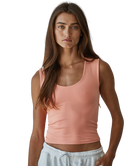 Woman wearing a pink tank top on a white background