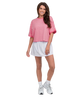 Woman wearing a pink and white striped shirt with a white skirt on a white background