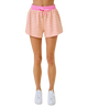Pink and yellow striped shorts worn by a person on a white background