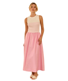 Woman wearing a sleeveless dress with a striped bodice and pink skirt on a white background