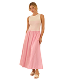 Woman wearing a striped sleeveless top and pink skirt on a white background