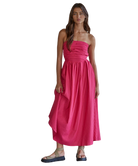 Woman wearing a pink strapless dress on a white background