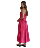 Woman wearing a pink strapless dress on a white background