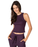 Woman wearing a purple tank and pants athleisure set outfit on a white background