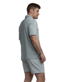 Man wearing a gray, blue, and purple striped polo shirt and shorts on a white background