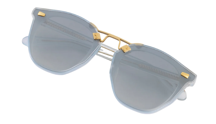 KREWE Sunglasses with gold accents and light blue lenses on a white background