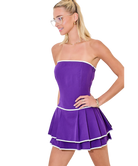 Woman wearing a purple dress with white trim on a white background