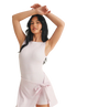 Woman wearing a light pink sleeveless dress with a white background