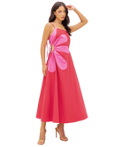 Woman wearing a pink dress with a floral design on a white background