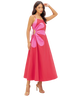 Woman wearing a pink dress with a floral design on a white background