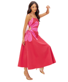 Woman wearing a pink dress with a cutout design on a white background