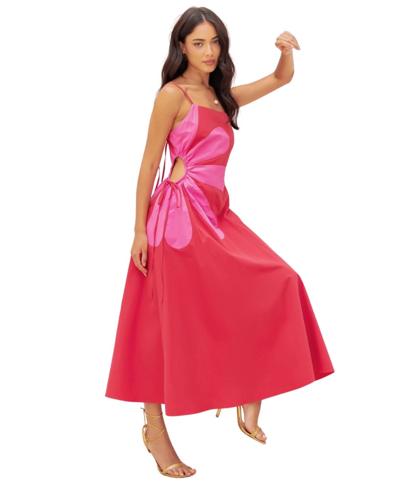 Woman wearing a pink dress with a cutout design on a white background